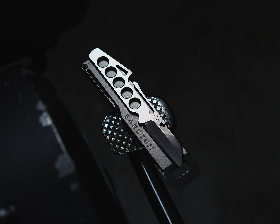 Slim fixed blade knife unsheathed and placed on top of the Sanctum Hard Bar pry sheath