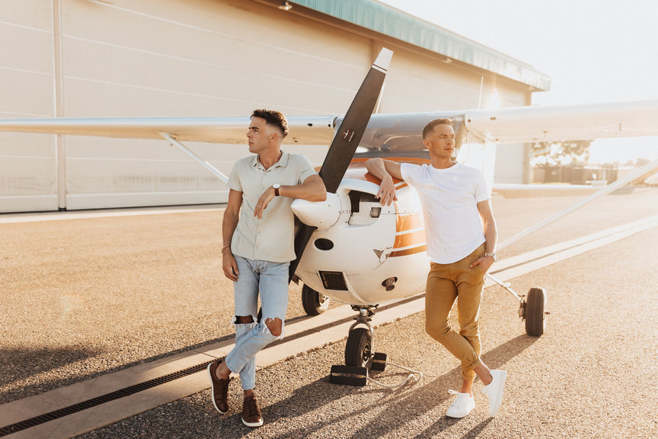 gay couple posing on airplane in utah