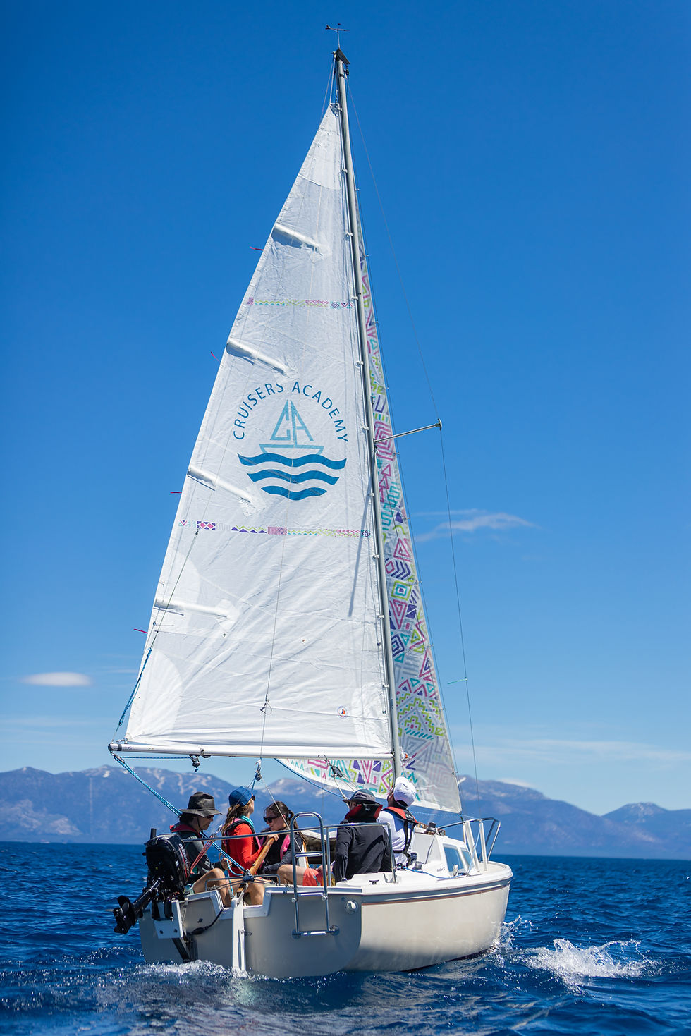 Catalina 22' sailing in front of the mountains.
