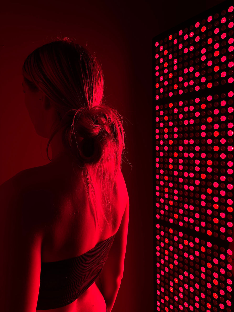 Near red light therapy panel at 20 Orange Spa in Wilmington, NC, used for seasonal skin recovery treatments.