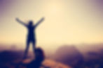 Silhouette of free cheering woman hiker open arms at mountain_ top cliff edge.jpg