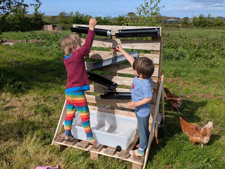 Children playing outdoors in Forest School in Somerset