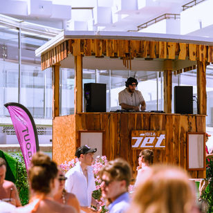 ibiza jet apartments, pool party, house music events, happy dj playing the decks, ibiza events, people dancing, ibiza playabout branded flags