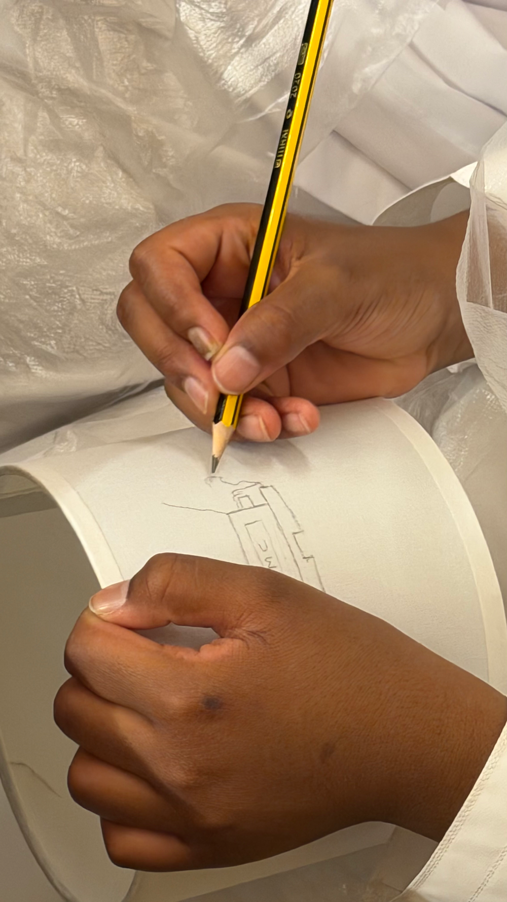 Hands sketching art with a pencil