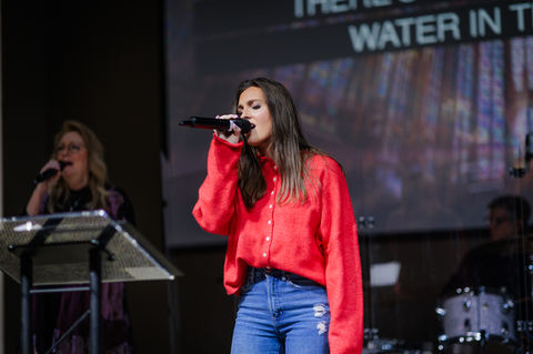 Woman singing on a praise team at church