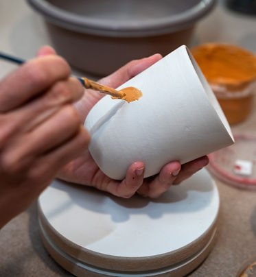 women-s-hands-painting-pottery-object.jpg
