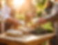 Firefly_A wooden table filled with bundles of herbs, vegetables, and small medicine bags,