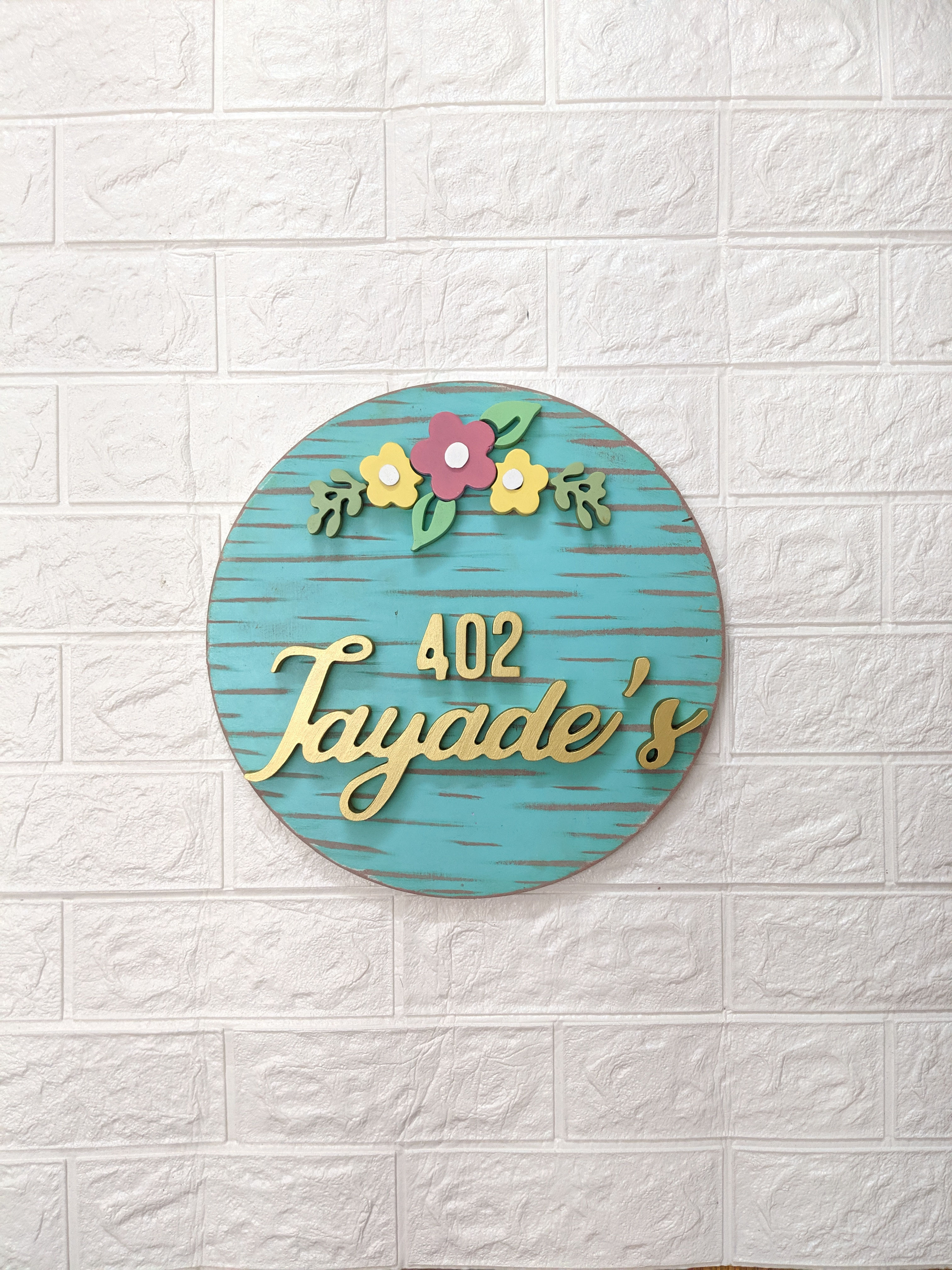 round floral nameplate in teal
