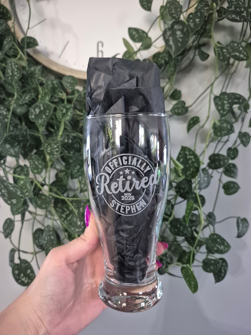 Thumbnail: Hand holding glass etched with 'OFFICIALLY Retired'