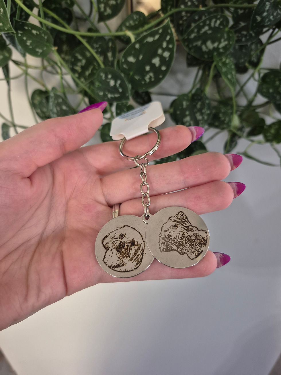 Thumbnail: Hand holding keychain with two etched dog face charms