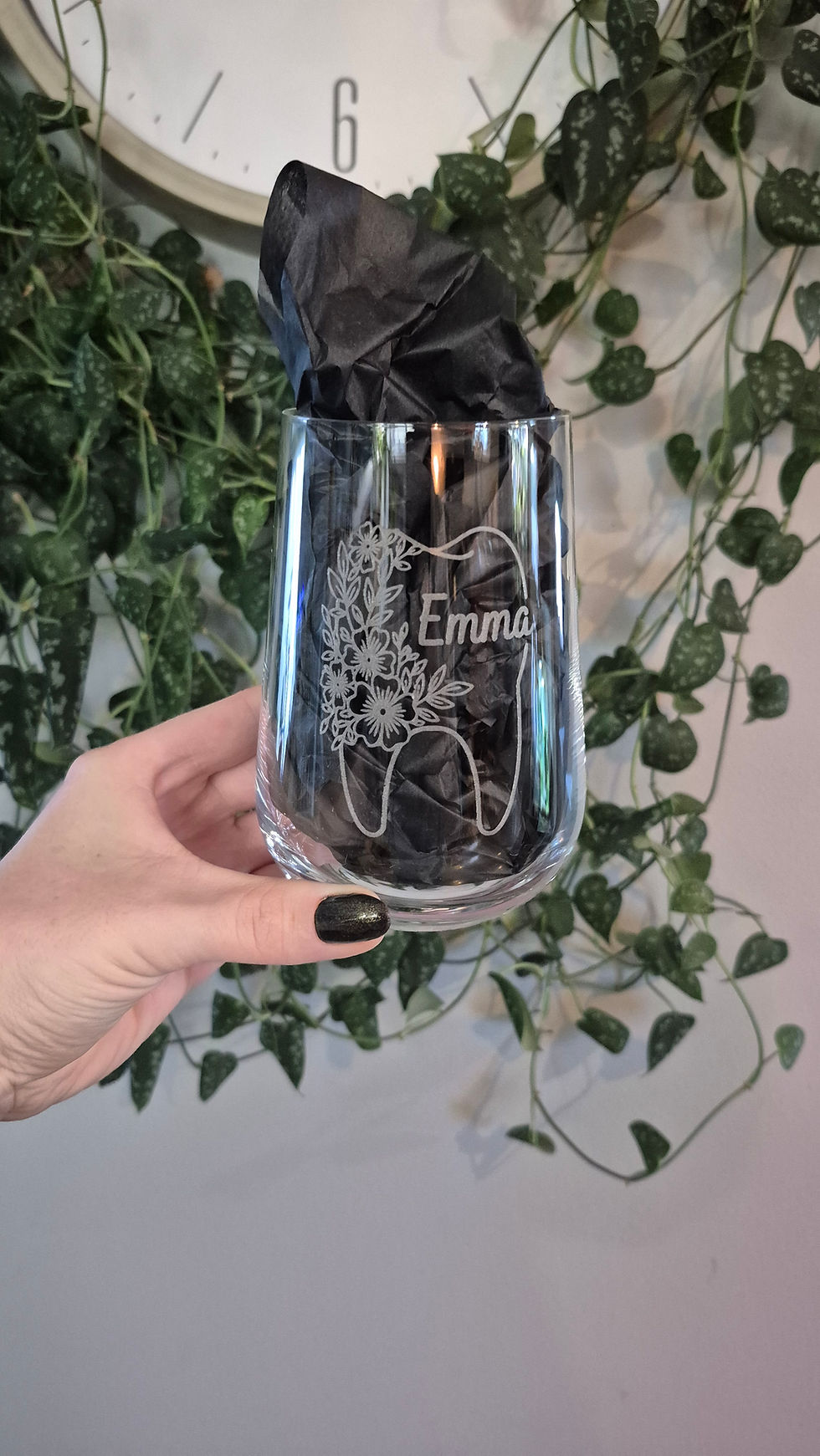 Thumbnail: Hand holding an engraved glass tumbler