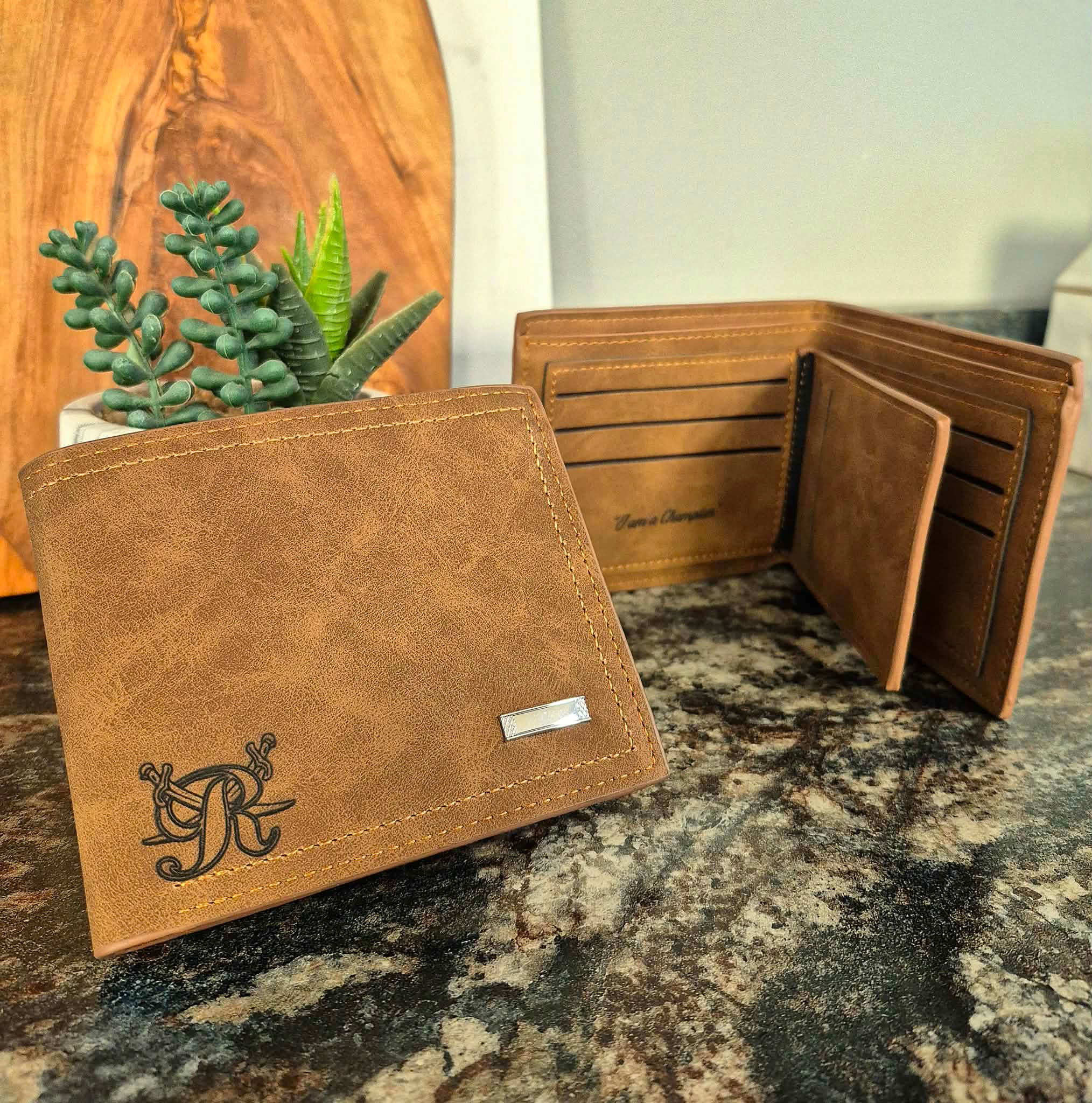 Two brown wallets, one monogrammed, one open with card slots