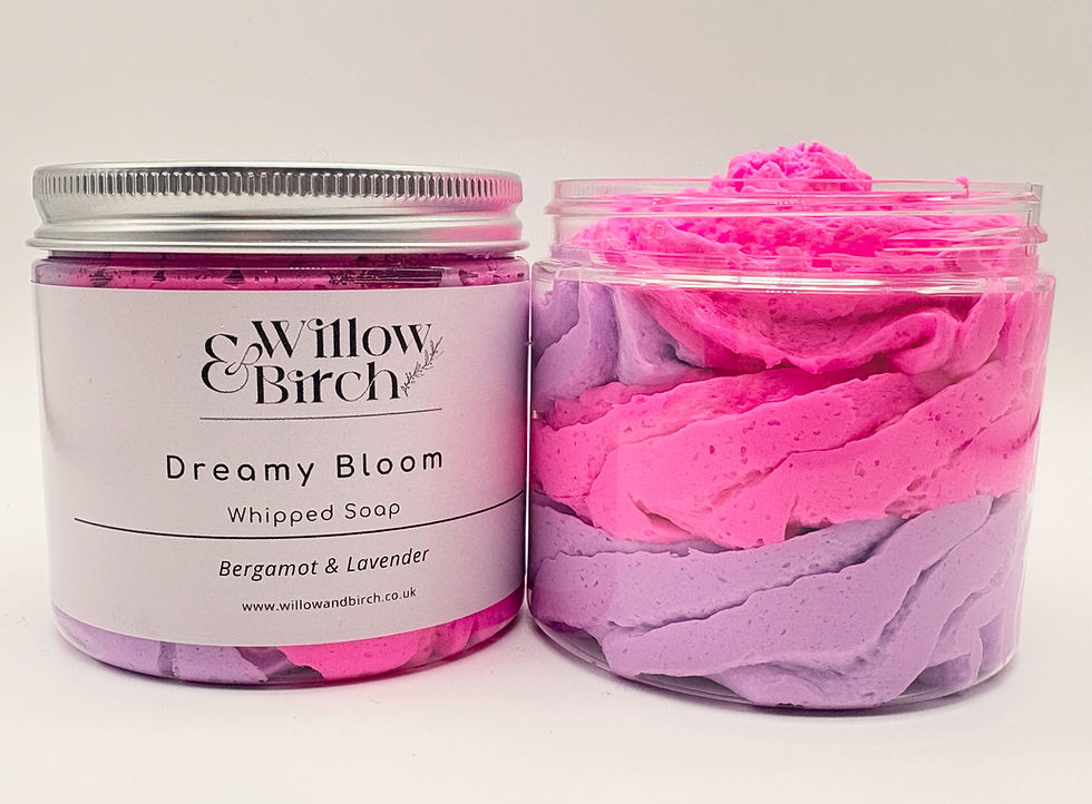 Two clear plastic pots with bright pink and purple fluffy whipped soap inside, one jar has label and silver lid on