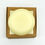 Thumbnail: A pale yellow coloured round conditioner bar sat on top of a small square brown box.