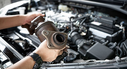 Close up old catalytic converter in hand Car service man