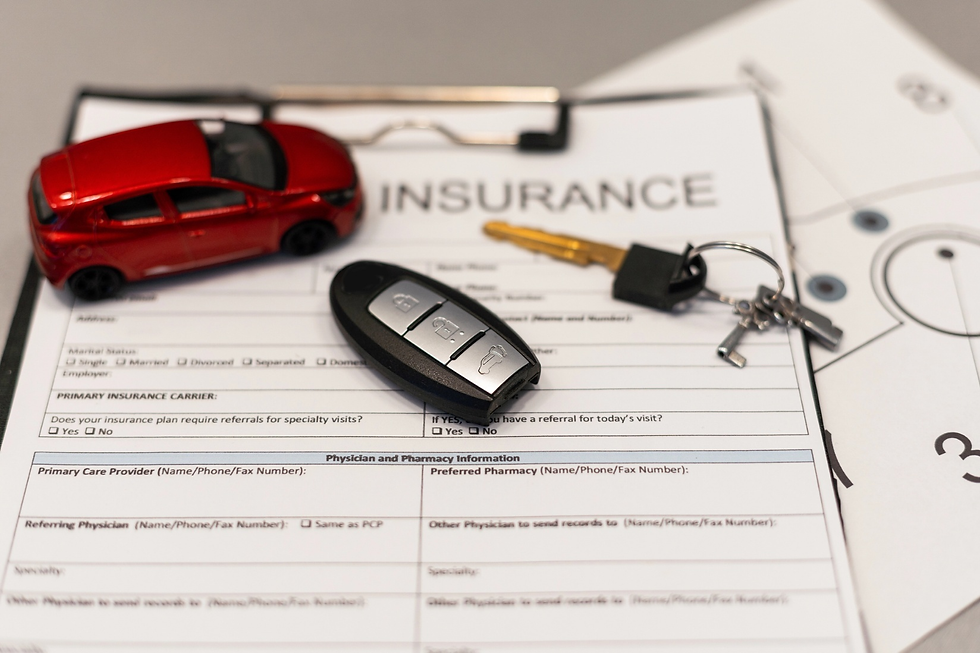 Auto insurance form with car key and red metallic toy van.