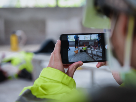 Smartphone shooting of an accident and unconscious worker in the workplace at a construction site.