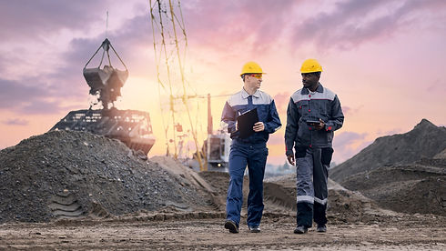 man wearing protective uniform using tablet on mining port