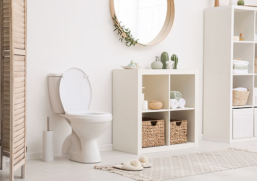 Modern toilet bowl near white wall in bathroom 
