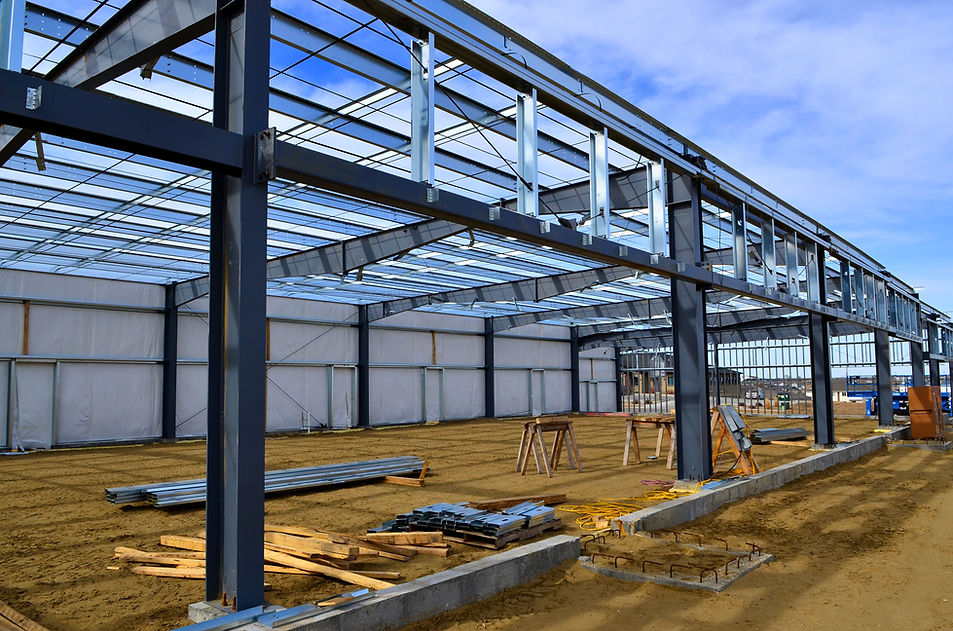 Large warehouse under construction, featuring a steel frame structure