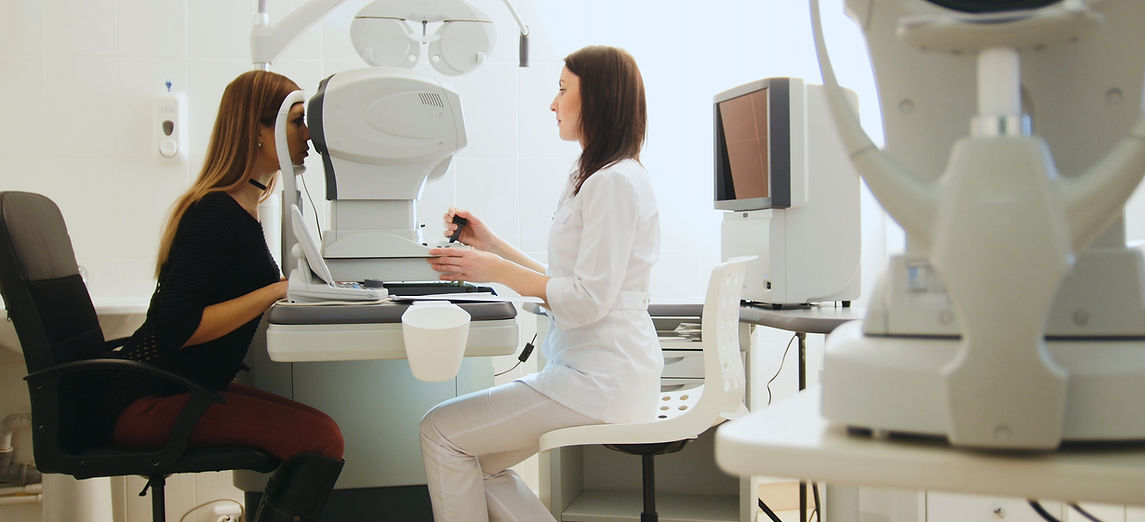 Female ophthalmologist examining senior woman's eyes
