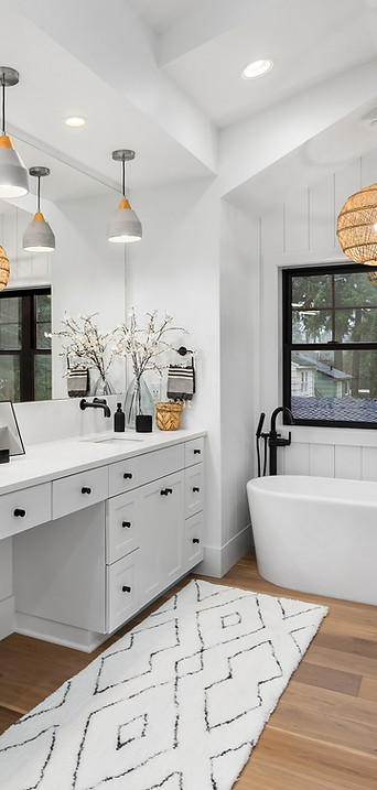 Modern white bathroom with double vanity and freestanding bathtub