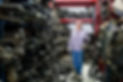 Worker walks through a car parts junkyard in the factory