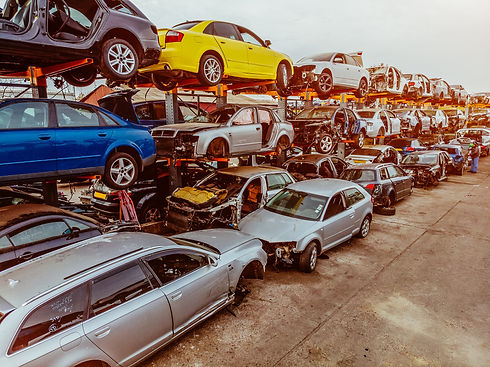 Damaged cars waiting in a scrapyard to be recycled or used for spare parts