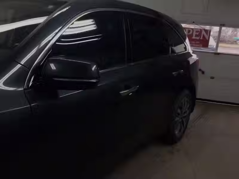 a dark grey SUV parked inside a garage