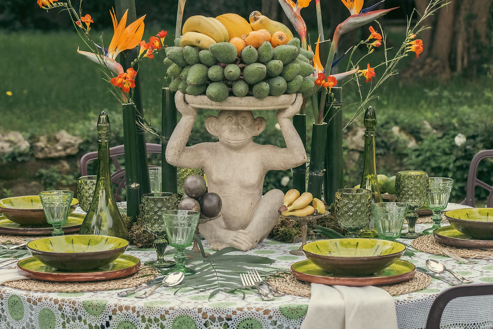 A sculptural monkey centerpiece filled with exotic fruit becomes the focal point of the entire tablescape