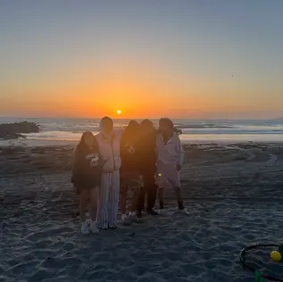 Group a kids on a beach at sunset