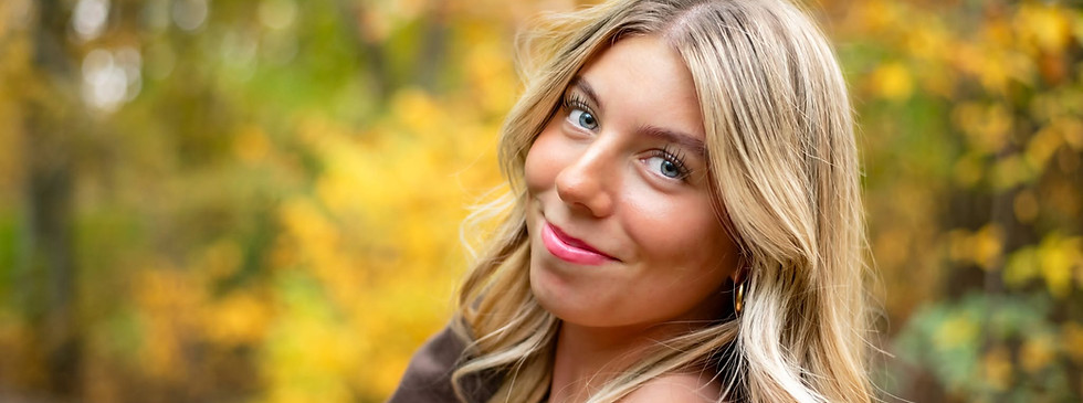 Senior girl smiling during a fall senior portrait session at Boundary Creek Natural Resource Area in Moorestown, NJ.