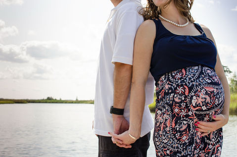 First-time parents-to-be holding hands during a September maternity photography session at Estell Manor Park in Estell Manor, NJ.