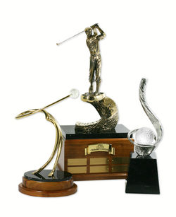 Photograph of three metal sculptural trophies.