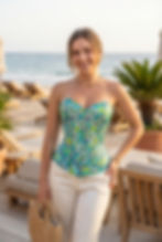 Female model is showcasing a green and turquoise printed satin overbust corset, showcasing its fit and style