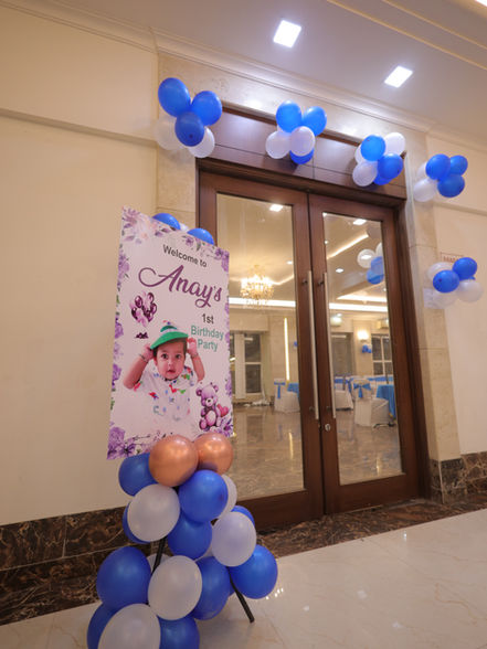 Balloon entrance decoration with first birthday welcome board at a party hall in Greater Noida