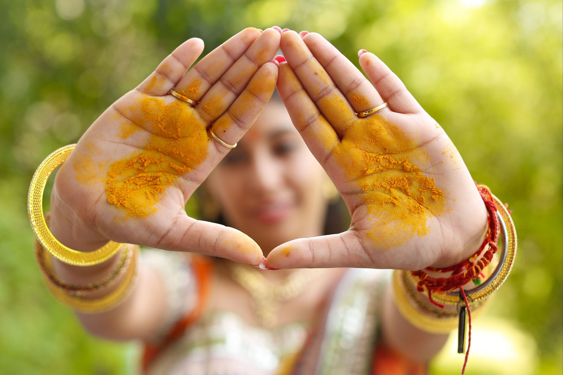 Hands covered in turmeric at a haldi