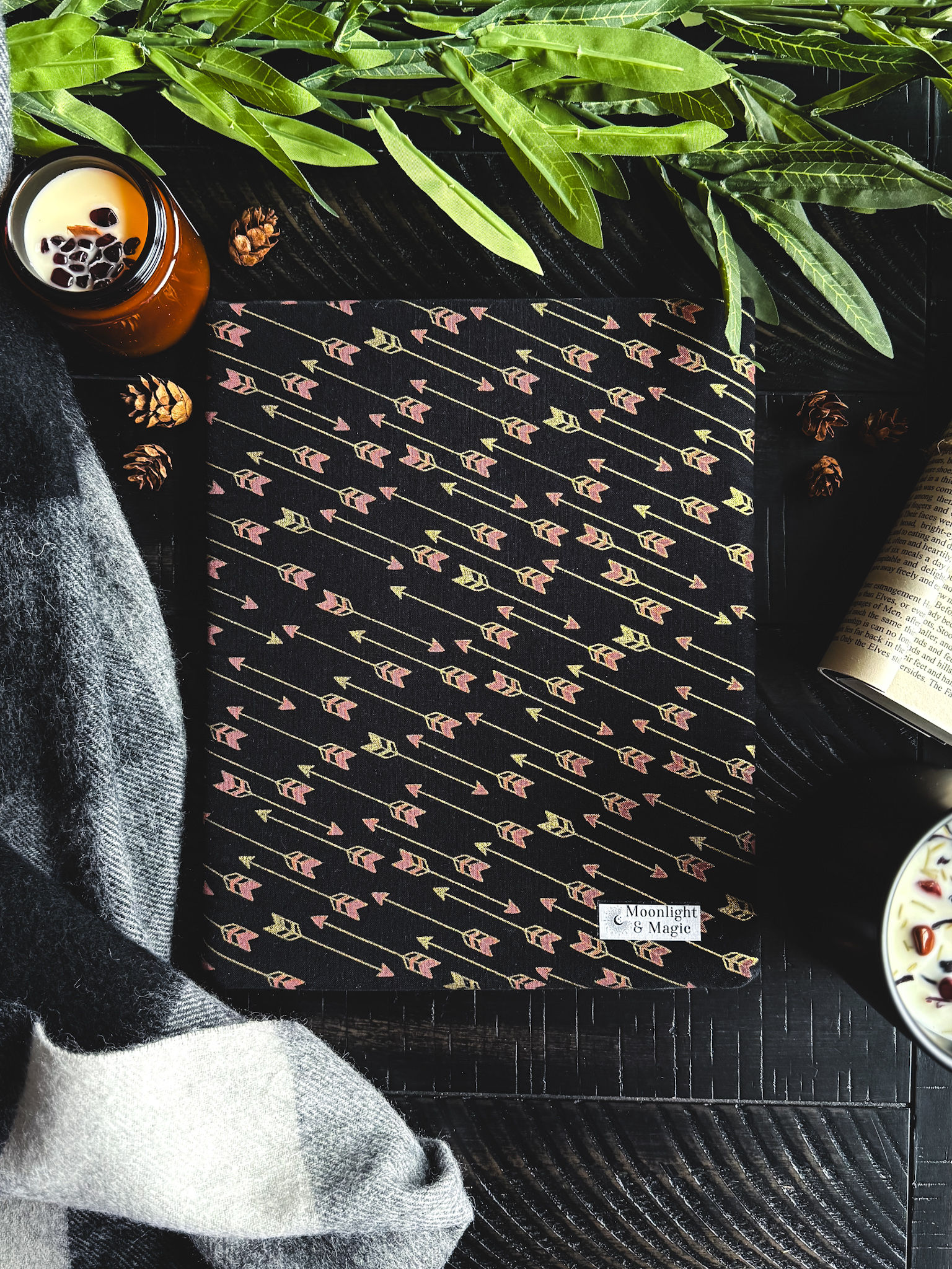 A book sleeve with a black background and gold and red arrows.