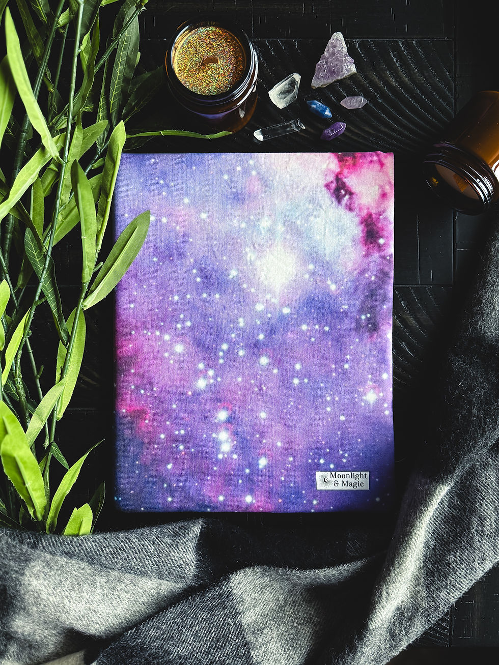 A book sleeve with a purple and pink galaxy print.