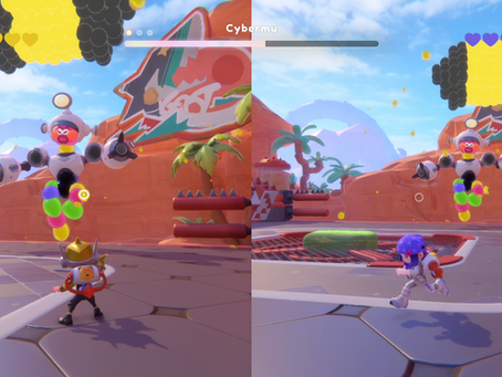 An in-game screenshot from Popucom. A split-screen view of a mini-boss fight, with two characters running in an outdoor stage with a bipedal monster made of various colored blobs runs at them. One of its legs is shorter than the other, having been shot by the players through the match-3 color shooting mechanic.