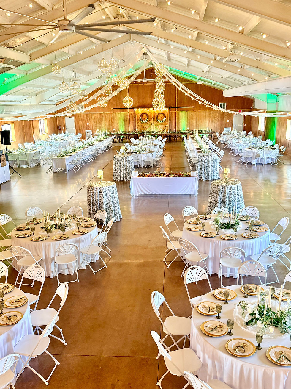 Wedding reception hall set with tables and open dance floor before guests arrive.