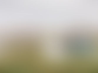 Wedding party taking photos at beautiful outdoor wedding venue in Amarillo: groom dips bride in white, groomsmen in beige cheer, bridesmaids in teal hold flowers, sky is overcast in West Texas.