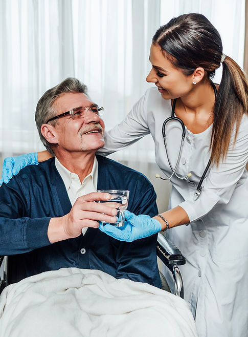 older-man-wheelchair-smiles-nurse-assistant-she-hands-him-glass-water.jpg