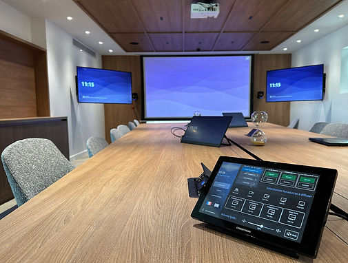Video conferencing room aboard a yacht with integrated screens and touchscreen audiovisual control