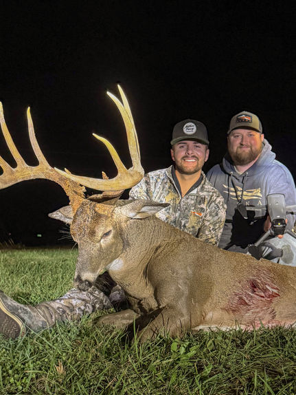 Creed David and the owner of 417 Drone Deer Recovery Jared Biastock taking a picture with a buck 