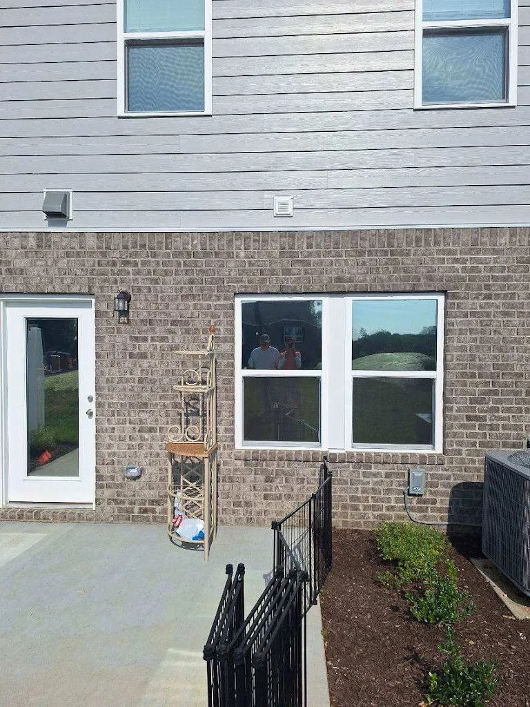 Back exterior of a house with a door and windows Residential Tint Elite Film Solutions