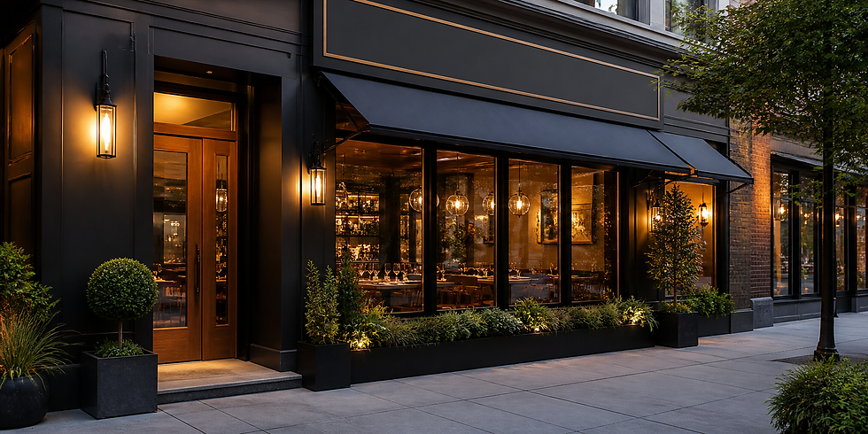 Elegant restaurant exterior with black facade, warm lights, and plants. Large windows reveal a cozy, inviting interior with set tables.