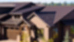 Picture of a reddish-brown snding seam metal roof on a residential home