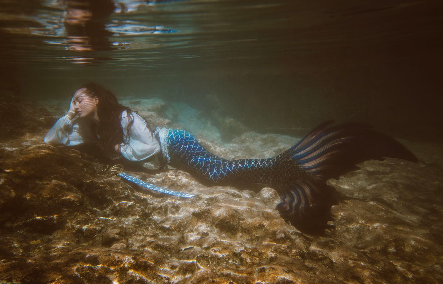 Pirate mermaid napping underwater on the coral reef. Fine art underwater portrait by Lexi Bird Photography, Bucks County PA