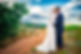 elopement-couple-nearly-kissing-along-dirt-trail-mountain-backdrop